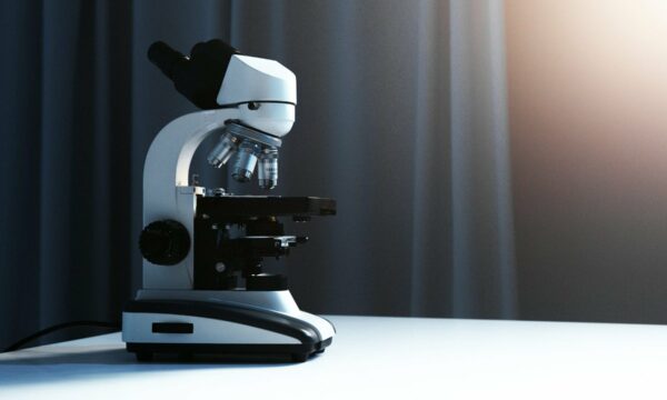 A Light Microscope Placed on a White Surface