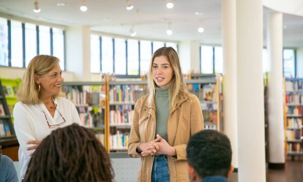 Young student making presentation to classmates and teacher